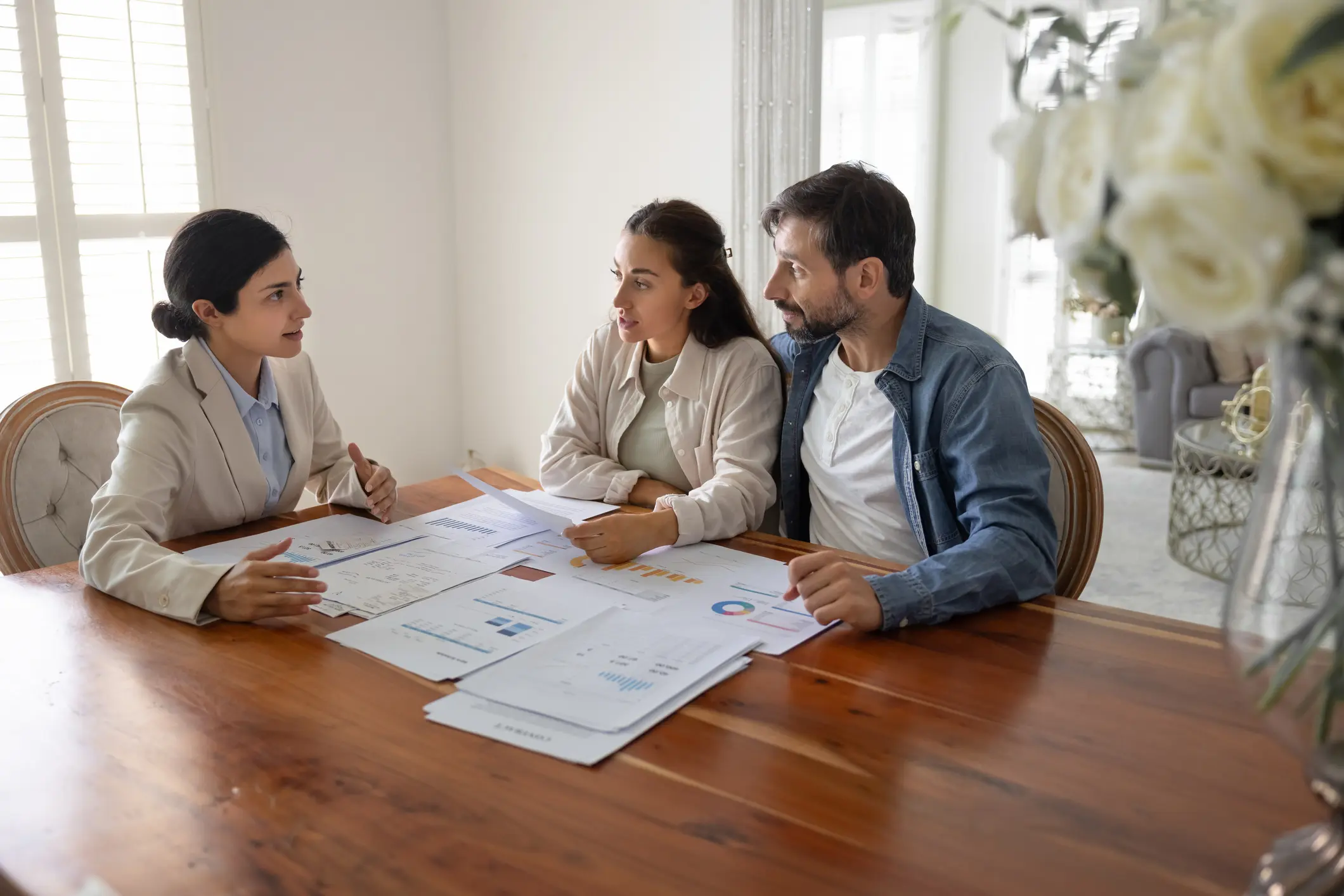 Meeting at table with documents and discussions.