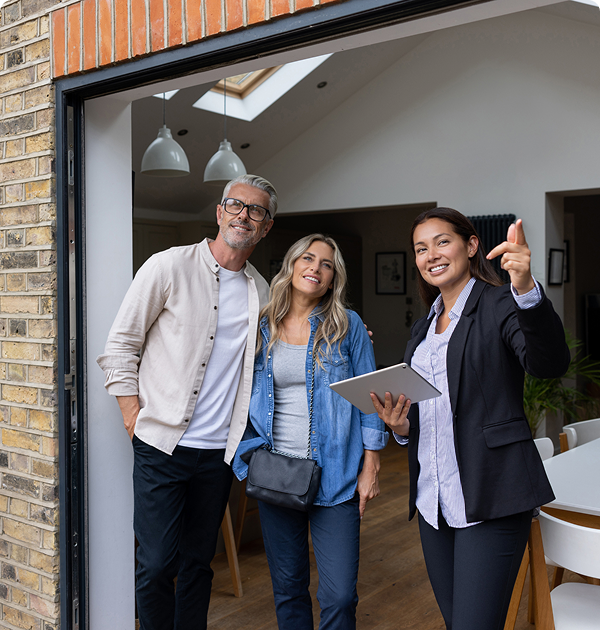 Real estate agent showing house to couple.